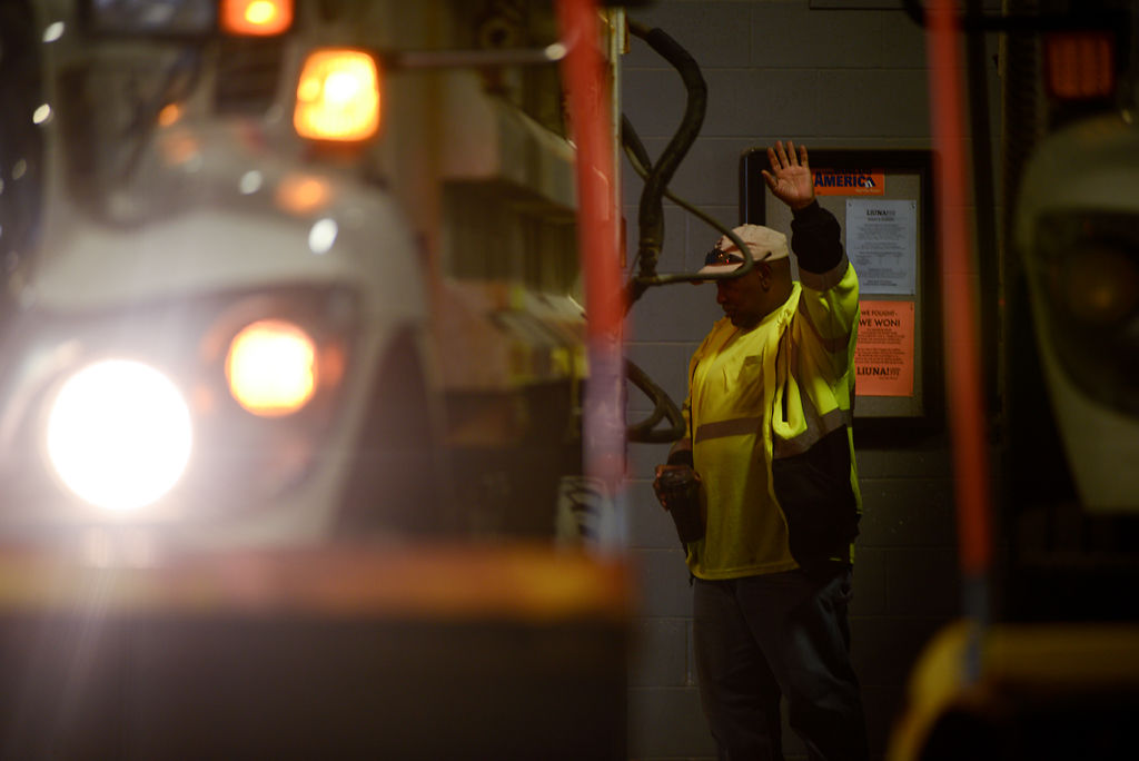 Gerod Crum keeps a look out for a colleague who is reversing his vehicle
